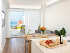 a kitchen and living room with a table with fruit on it at Apartment D'Mediterranea private pool & sauna by Interhome in Torrox Costa
