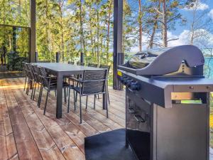 a kitchen with a stove and a table on a deck at Holiday Home Villa haave by Interhome in Kustavi