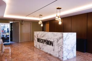 a lobby with aidium sign on a marble wall at Hotel 6 Marsi in Golem +114 photos