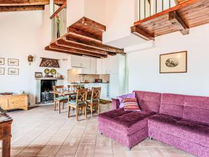 a living room with a purple couch and a table at Apartment Laghina by Interhome in Musso