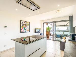 a kitchen with a island in the middle of a room at Apartment Entre Bateau et Mer by Interhome in Santo Stefano al Mare +23 photos