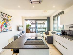 a kitchen and living room with a table in a room at Apartment Entre Bateau et Mer by Interhome in Santo Stefano al Mare