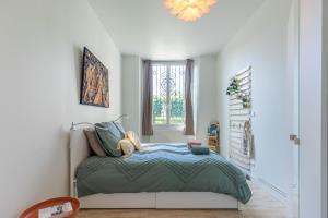 a bedroom with a bed and a window at La Belle Epoque in Vendôme