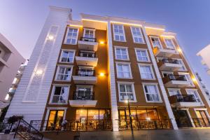 a tall building with windows and balconies on it at Hotel 6 Marsi in Golem