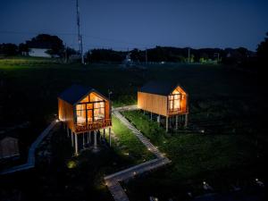 zwei kleine Häuser auf einem Feld bei Nacht in der Unterkunft Suspended Tiny House in Drumu Carului