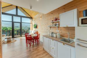eine Küche und ein Esszimmer mit Tisch und Stühlen in der Unterkunft Suspended Tiny House in Drumu Carului + 32 Fotos