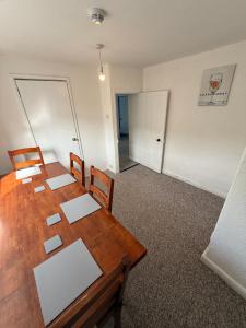 an empty room with a wooden table and chairs at Large 1 Bed flat in Camelford +4 photos