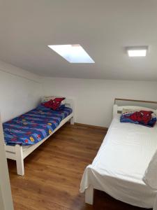 a bedroom with two beds and a skylight at Mountain View in Bar +2 photos