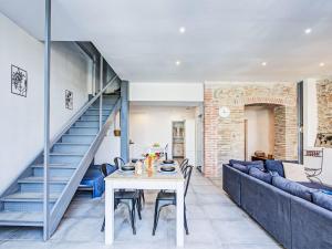 a living room with a table and a staircase at Holiday Home La Grange by Interhome in Torreilles