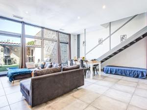 a living room with a couch and a table at Holiday Home La Grange by Interhome in Torreilles +26 photos