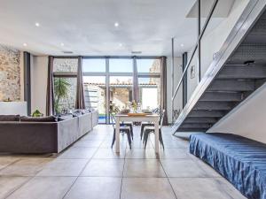 a living room with a table and a couch at Holiday Home La Grange by Interhome in Torreilles