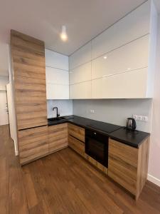 a kitchen with a black counter and a sink at Arcadia Studio 238-1 in Odesa