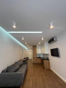 a living room with a couch and a kitchen at Arcadia Studio 238-1 in Odesa