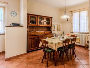 a kitchen with a table and chairs in a room at Apartment Torchio by Interhome in Carlazzo +22 photos