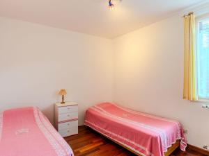 a bedroom with two beds and a window at Apartment Torchio by Interhome in Carlazzo