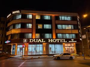 a car parked in front of a hotel at night at Dual Hotel Halkalı in Istanbul