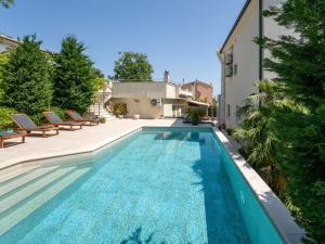 a swimming pool in the backyard of a house at Apartment Dita-4 by Interhome in Crikvenica