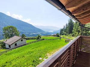 a view from the balcony of a house with a green field at Apartment Larice Quadrilocale by Interhome in Livo