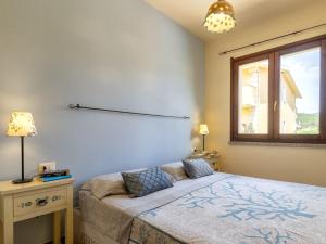 a bedroom with a bed and a window at Apartment Del Colle by Interhome in Viddalba