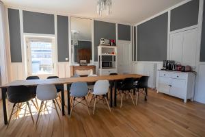 a dining room with a table and chairs at La Demeure Du Tabellion in Mont-Dore +19 photos