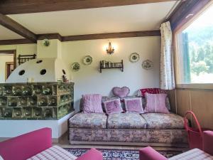 a living room with a couch and a window at Chalet Altavista by Interhome in Ziano di Fiemme +87 photos