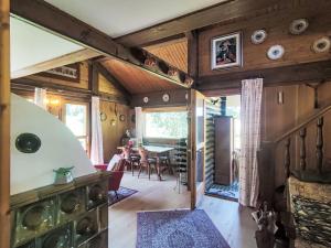 a living room with a table and a dining room at Chalet Altavista by Interhome in Ziano di Fiemme