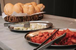 a table with plates of food and bowls of food at Vicz Palace Hotel in Curitiba
