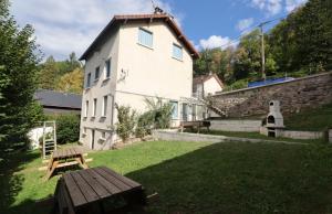 a building with a picnic table in a yard at Les Agapanthes in La Bourboule