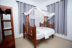 Postel nebo postele na pokoji v ubytování Michamvi Holiday Homes- 102