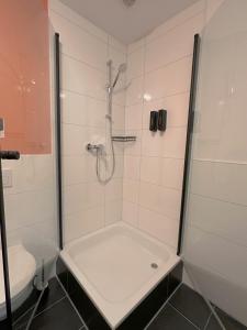 a bathroom with a shower and a toilet at CASE Living Marl in Marl +14 photos
