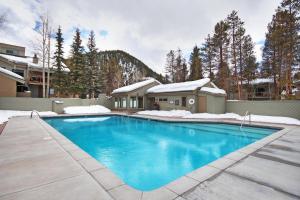 a swimming pool in front of a house at Flying Dutchman 1155 by SummitCove Lodging in Keystone +46 photos
