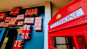 a red telephone booth with wrapped boxes on the wall at Rest Up London in London +103 photos
