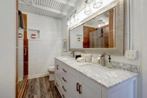 a white bathroom with a sink and a mirror at Bougie Squirrel Glam Pad in Nashville +46 photos