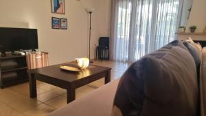 a living room with a couch and a coffee table at Keramoti Luxury Apartments in Keramotí