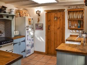 a kitchen with white appliances and a white refrigerator at Honeysuckle Cottage in Great Yarmouth +13 photos