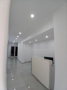 an empty room with white walls and a lobby at Villa Allkushi in Sarandë