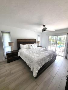 a bedroom with a large bed and a ceiling fan at Emerald House in Bradenton