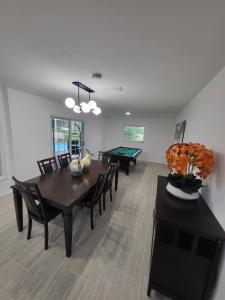a dining room with a table and ping pong ball at Emerald House in Bradenton +17 photos
