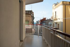 a balcony of a building with a chair on it at Domus Aurea in Termoli
