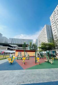 a playground in a city with yellow chairs and buildings at Zen Vibes Modern 2BR Asian Fusion Stay in Manila