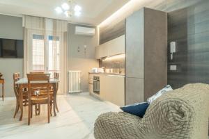 a living room and kitchen with a table and a chair at Domus Aurea in Termoli