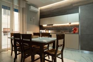 a kitchen with a dining room table and chairs at Domus Aurea in Termoli +14 photos
