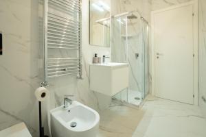 a white bathroom with a sink and a shower at Domus Aurea in Termoli