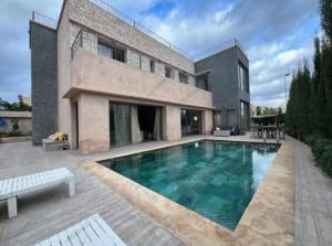 a house with a swimming pool in front of it at Villa Rose du désert in Essaouira