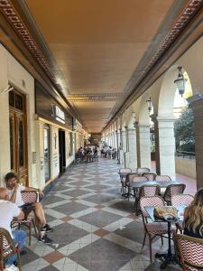 a hallway with people sitting in chairs in a building at Quiet flat center Monaco in Monte Carlo