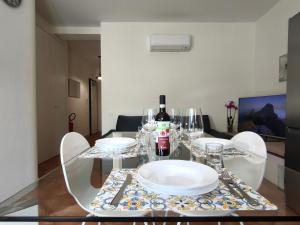 a dining room table with plates and wine glasses at La Porta della COSTIERA in Cava deʼ Tirreni