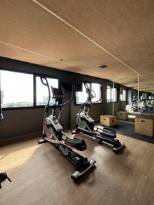 a gym with three exercise bikes in a room at NOVO Skylux 1109 Imponente com Piscina Aquecida WIFI in Rio de Janeiro