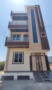a tall building with a balcony on the side of it at Elegant & Spacious Venue in Kota