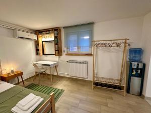 a room with a table and a desk in it at M Place in Zvezdara