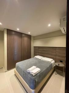 Ένα ή περισσότερα κρεβάτια σε δωμάτιο στο Apto Grand- Ithiel